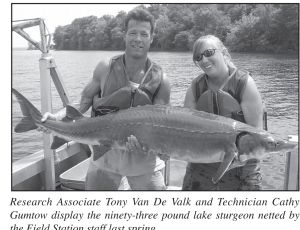 Research Associate Tony Van De Valk and Technician Cathy Gumtow display the ninety-three pound lake sturgeon netted by the Field Station staff.